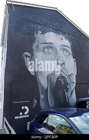 Iconic Port Street, Ian Curtis mural by @Akse P19 in Manchester Northern Quarter NQ4, overwritten by Amazon Music rapper Aitch, 16th August 2022 Stock Photo