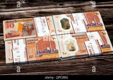 Stack of new first Egyptian 10 LE EGP ten pounds plastic polymer banknote features Administrative capital's grand mosque Al-Fattah Al-Aleem, the pyram Stock Photo