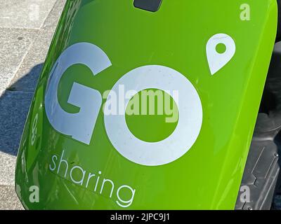 Zandvoort, Netherlands - August 12. 2022: Closeup of green white GO Sharing Company logo lettering on electric scooter front Stock Photo
