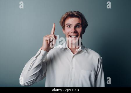 Young man pointing and forefinger index finger up Stock Photo