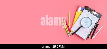 Background with school supplies on a pink background. Stock Photo
