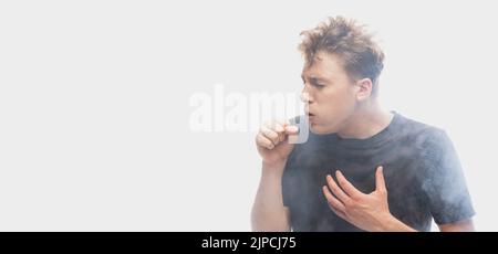 Suffocate in the smoke. Scared young man with stressed emotions isolated over white background with clouds of smoke. Concept of facial expression Stock Photo