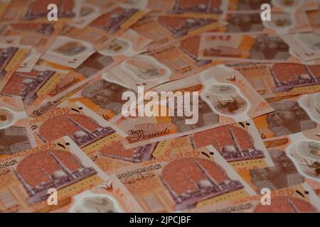Pile of the new first Egyptian 10 LE EGP ten pounds plastic polymer banknote features Administrative capital's grand mosque Al-Fattah Al-Aleem, the py Stock Photo