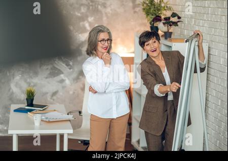 Colleagues discussing project details and looking involved Stock Photo