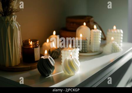 Beautiful composition with grey and white babble candles for spa treatment or home interior. Zen and relax concept. Stock Photo