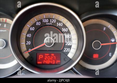 selective focus of a car dashboard details set of a parking vehicle and engine is turned on, speedometer, RPM revolutions per minute, petrol meter and Stock Photo