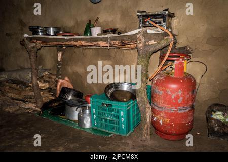 July 7th 2021 Uttarakhand India. Traditional kitchen made of mud and clay in rural Household with fuel tank and kitchenware. Stock Photo