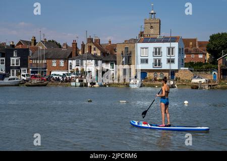 WIVENHOE IN ESSEX, PICTURED FROM THE OPPOSITE SHORE (ROWHEDGE). THE ROSE AND CROWN PUB IS VISIBLE Stock Photo