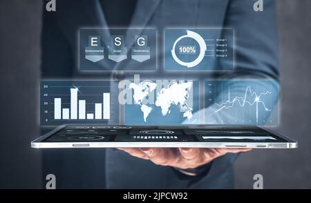 Businessman use tablet for analyze return on investment ESG. ESG environmental social governance business strategy investing concept. Modern digital t Stock Photo