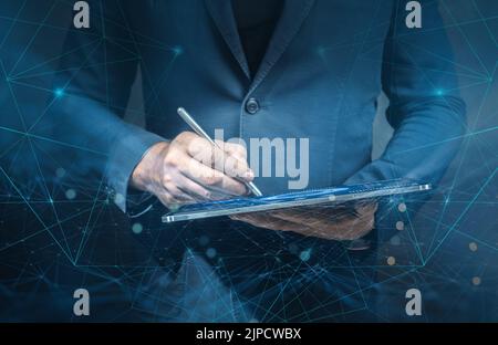 businessman working with modern computer interface as information technology concept. Man using tablet analyzing sales data and economic growth graph Stock Photo