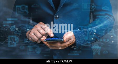 Businessman using cellphone with modern virtual interface. Digital online marketing, Businessman using smartphone and analysis sale data graph growth Stock Photo