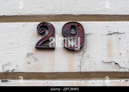 Number twenty nine on peeling wall by doorway Stock Photo