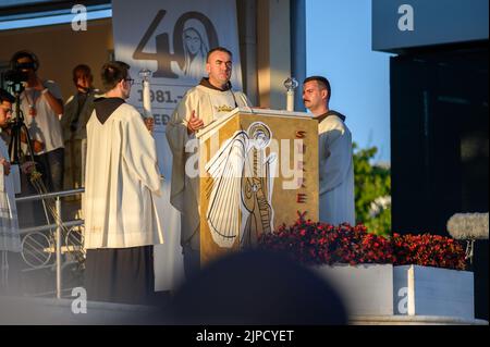 Fr Marinko Šakota reading the Gospel during the evening Holy Mass during Mladifest 2021 in Medjugorje. Stock Photo