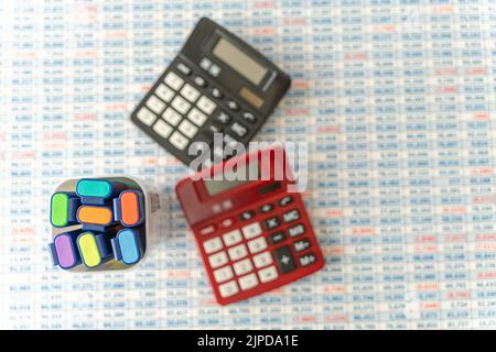 Highligters with Calculators on top of Spreadsheet background Stock Photo