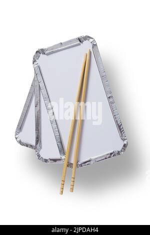 Pile of three silver foil takeaway trays with chopsticks placed on top isolated on white with path cut out Stock Photo