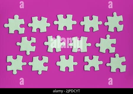 Jigsaw puzzle on purple background with customizable space for text or ideas. Copy space. Stock Photo