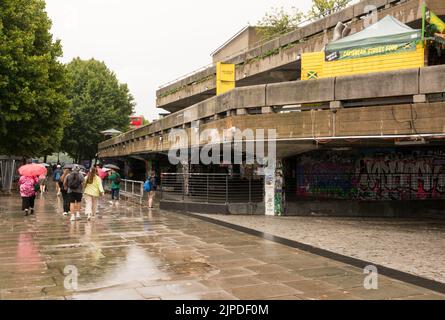 London, England, UK. 16 August 2022.  The drought and heatwave in the UK is finally over - tourists enjoying cooler weather and some rain at London's Southbank Centre, London, England, UK © Benjamin John Stock Photo