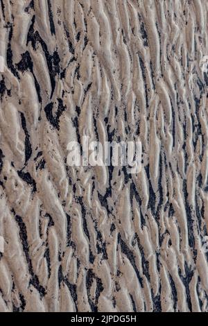 natural sand pattern on the beach. Sand surface with pattern, sand texture background Stock Photo