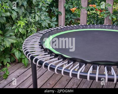 detail of mini trampoline for fitness exercising and rebounding in a backyard patio Stock Photo