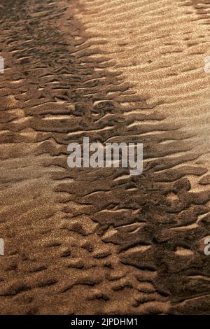 natural sand pattern on the beach. Sand surface with pattern, sand texture background Stock Photo