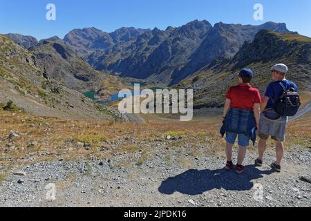 CHAMROUSSE, FRANCE, August 1, 2022 : Hikers on the paths around Robert Lakes, a famous destination for hikers in Chamrousse mountain resort Stock Photo