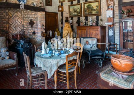 Old dining room with antique furniture and vintage chairs and table at the open air museum Bachten de Kupe, Izenberge, West Flanders, Belgium Stock Photo