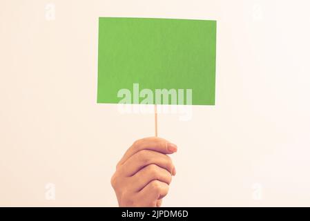 Man Showing Recent Informations On Notebook On Desk With Notes And Pencils. Businessman Presenting Important Message On Notepad On Table With Memos. Stock Photo