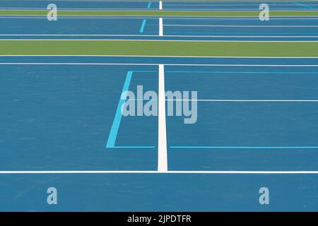 New blue outdoor combined tennis courts with white lines and light blue pickleball lines Stock Photo