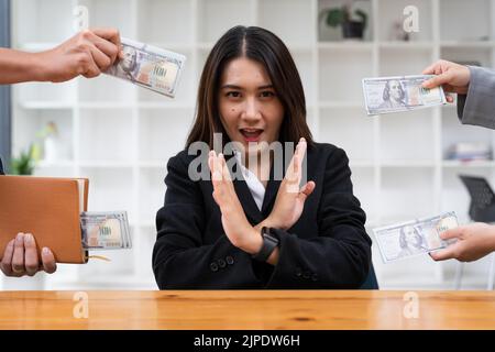 Asian woman refusing money in the envelope to agreement contract, Bribe and corruption concept Stock Photo