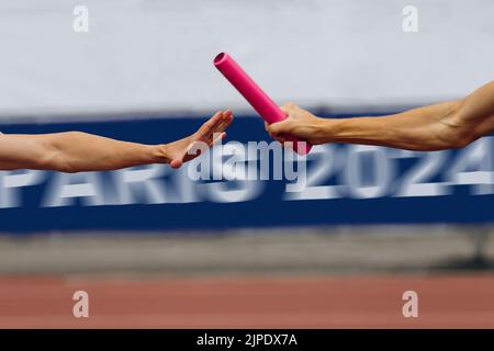 men relay race in background banner Paris 2024 Stock Photo