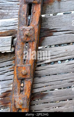 Beach pebbles caught in a breakwater Stock Photo - Alamy
