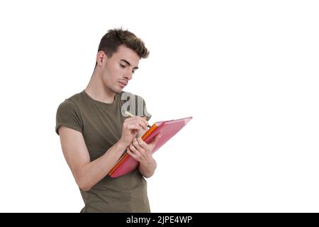 Young caucasian student writing on a folder, isolated. Stock Photo