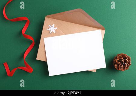 Christmas letter mock up with blank card and winter decorations. Communication, greeting, invitation concept. Stock Photo