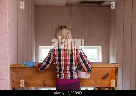 Woman cleaning and wiping with microfiber cloth. Woman doing chores at home. Housekeeping concept. Stock Photo