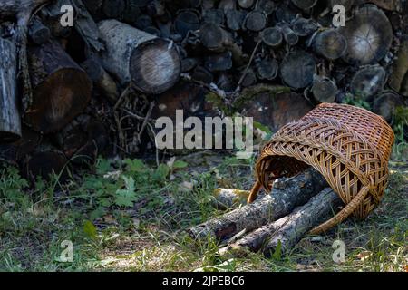 overturned basket with firewood lies in the garden. High quality photo Stock Photo