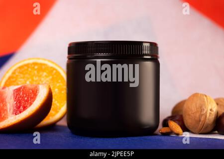 black plastic jar without logo and fruit. Stock Photo
