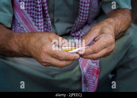 Hands rolling cigarette in the Southeastern Turkey Stock Photo