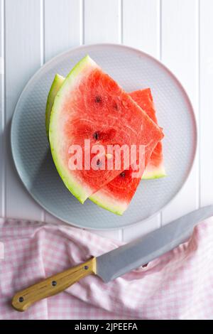 Slices of red watermelon on a plate. Top view. Stock Photo