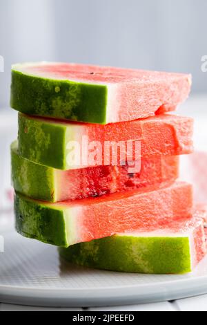 Fresh Watermelon Slice With Juicy Red Flesh And Whole Watermelon On fresh-watermelon-slice-with-juicy-red-flesh-and-whole-watermelon-on