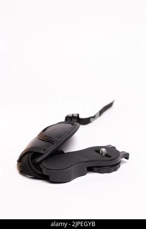 black leather camera strap on white background. Stock Photo