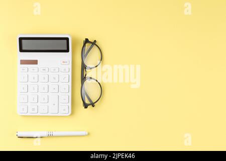 Glasses calculator and pen top view. Stock Photo