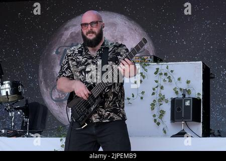 Winchester, UK. 14th Aug, 2022. Jonathan 'Jon' Doyle bass guitar player with British reggae punk band The Skints seen performing live on the Grand Central stage during the Fair Festival. Boomtown is a British music festival held every year on the Matterley Estate in South Downs National Park, near Winchester. Credit: SOPA Images Limited/Alamy Live News Stock Photo