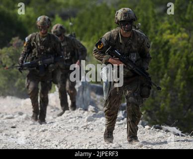 Fort Hood, Texas, USA. 16th Aug, 2022. Sergeant Andrew Row from 2nd Brigade Combat Team Strike 101st Airborne Division (Air Assault), 18th Airborne Corps, moves ahead during a road march to an objective during the FORSCOM Best Squad Competition on Fort Hood, Texas, August 16, 2022. Each of these events are designed to test the physical and mental toughness along with the lethality of each squad to see which squad will represent FORSCOM at the Best Squad of the Army competition that will take place at Ft. Bragg, NC. Credit: U.S. Army/ZUMA Press Wire Service/ZUMAPRESS.com/Alamy Live News Stock Photo