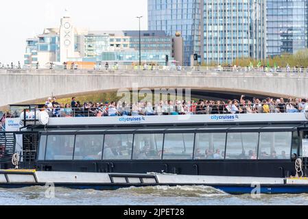 CityCruises, by Hornblower, sightseeing vessel passing under Waterloo Bridge in London on the River Thames. Boat trip Stock Photo