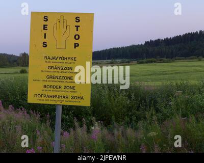 This sign marks the border zone between Finland and Russia, as seen from the Finnish side. It's just outside a little Finnish village called Vartsila. Stock Photo