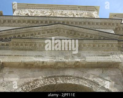 The ornate carving at the top of the Roman Triumphal Arch in the town of Orange, built at the time of Emperor Augustus in the first century. Stock Photo