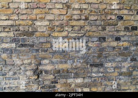 Close up of evenly laid brick wall with different colored ashlar rails to use as background synonym for wall, brick and old buildings Stock Photo