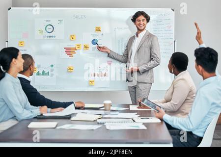 Business coach presenting marketing or financial budget report and accounting statistics or sales charts on white board. Leader and mentor discussing Stock Photo