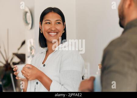 Woman drinking coffee, having conversation and bonding with her husband at home. Smiling, happy and relaxed wife enjoying quality time, romantic and Stock Photo