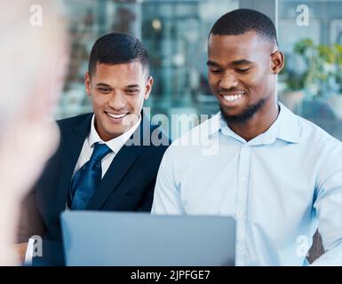 Cooperation, teamwork and working together on laptop male colleagues, businessmen or entrepreneurs smiling and satisfied with report. Happy and Stock Photo